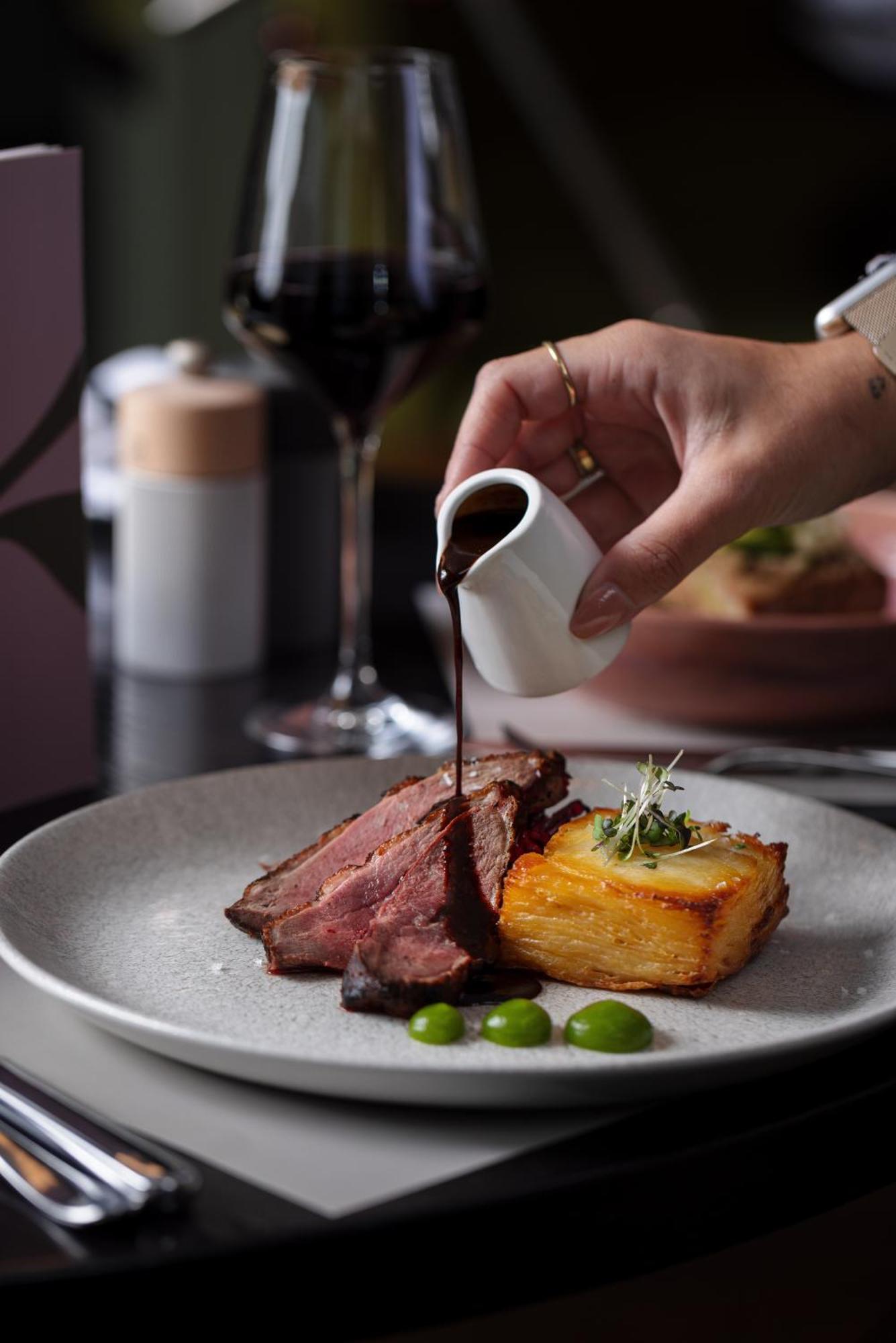 Готель The Morrison Dublin, Curio Collection By Hilton Екстер'єр фото A steak being drizzled with a sauce
